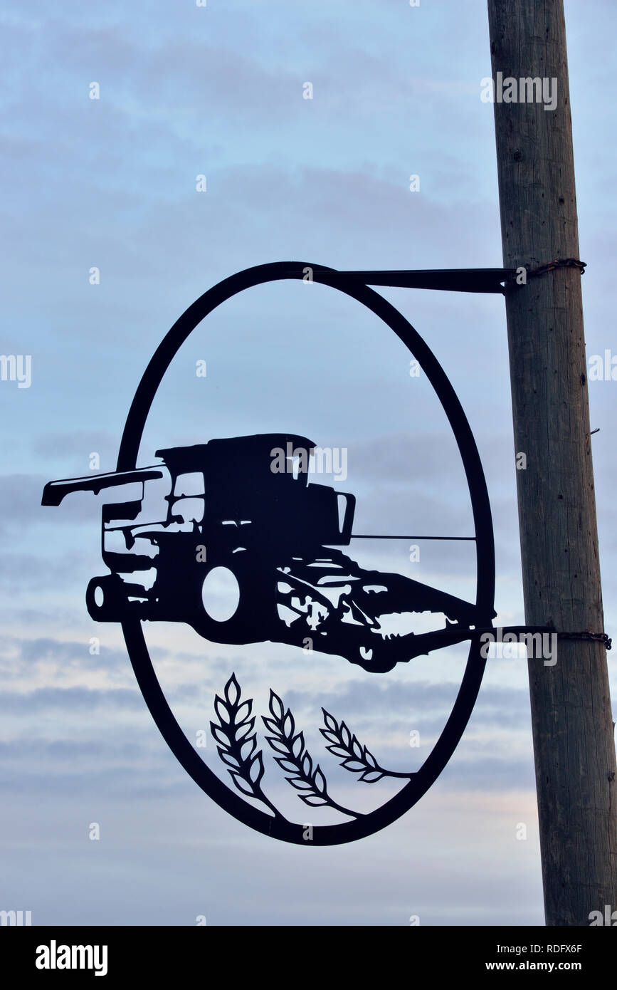 Decorative metal sculpture attached to street light poles, Waskatenau