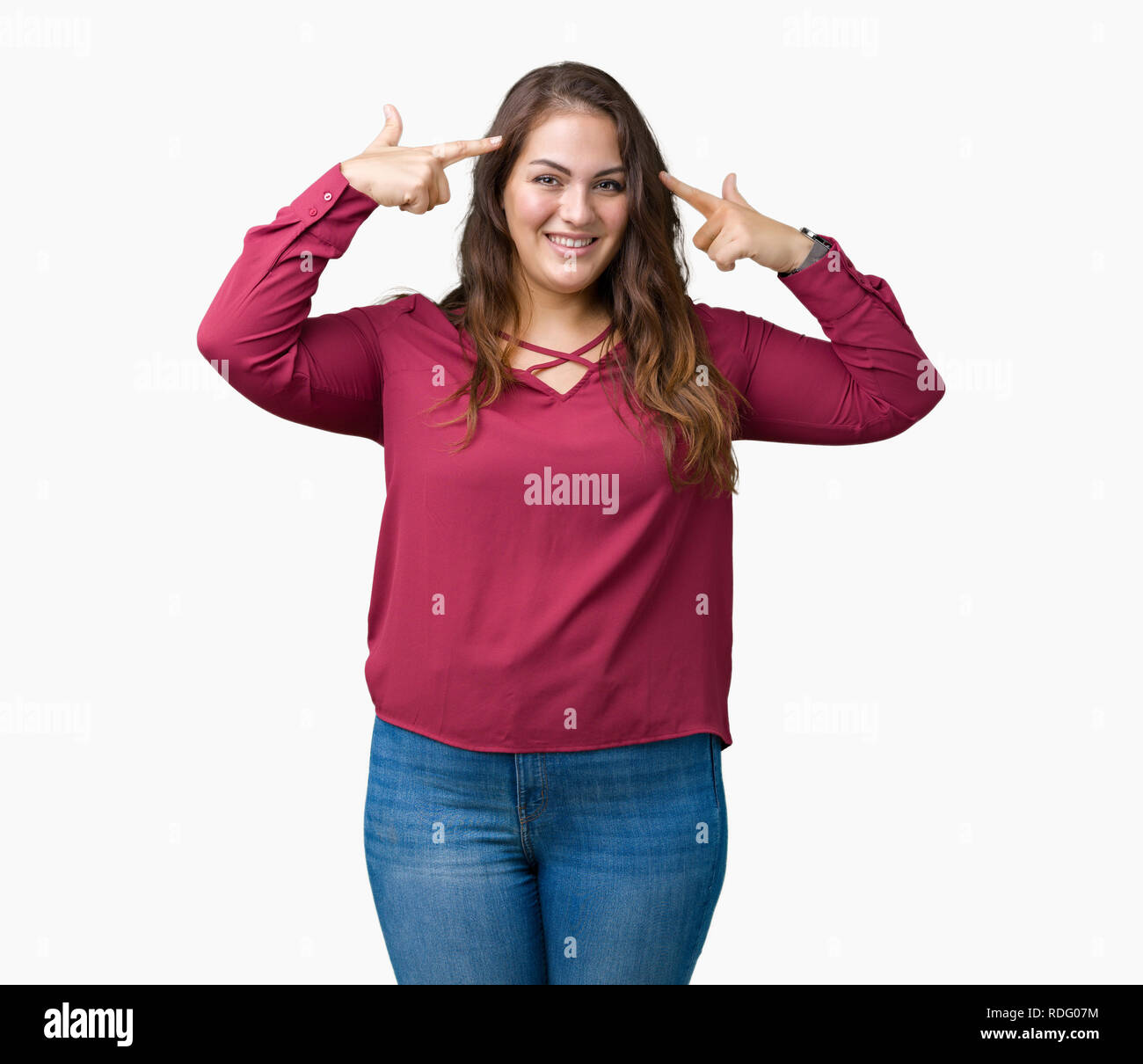 Beautiful plus size young woman over isolated background Smiling pointing to head with both hands finger, great idea or thought, good memory Stock Photo