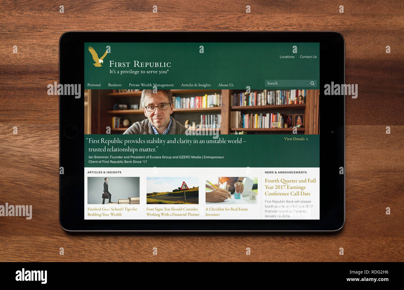 The website of First Republic bank is seen on an iPad tablet, which is resting on a wooden table (Editorial use only). Stock Photo