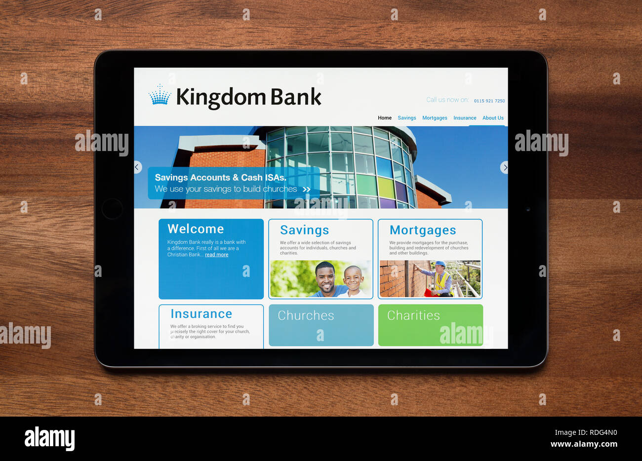 The website of Kingdom Bank is seen on an iPad tablet, which is resting on a wooden table (Editorial use only). Stock Photo