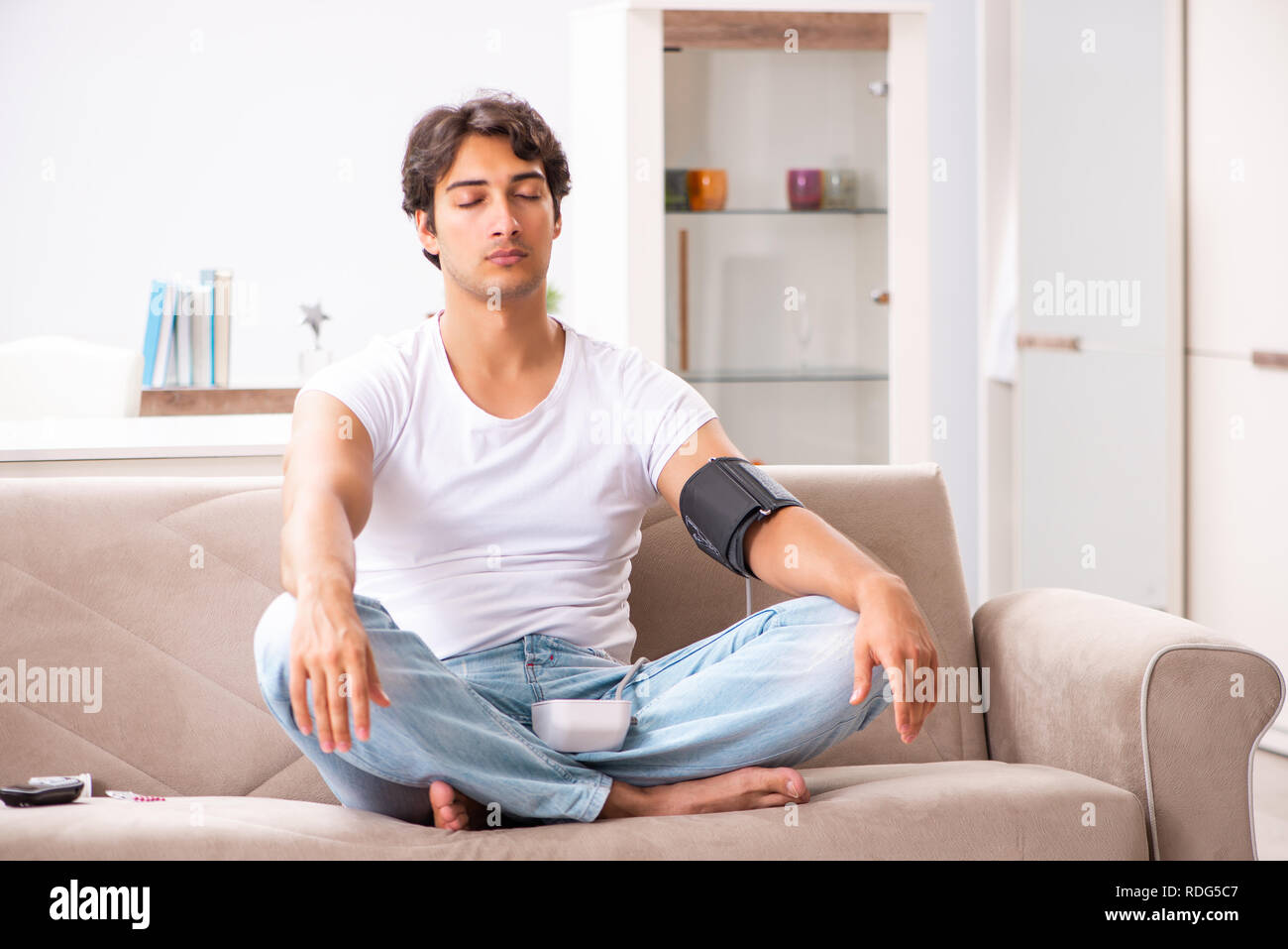 Young Man Measuring Blood Pressure At Home Stock Photo Alamy young-man-measuring-blood-pressure-at-home-stock-photo-alamy