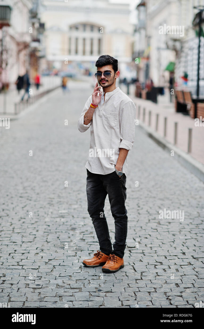Stylish indian model man in casual clothes and sunglasses posed outdoor at  street of India and speaking on mobile phone Stock Photo - Alamy