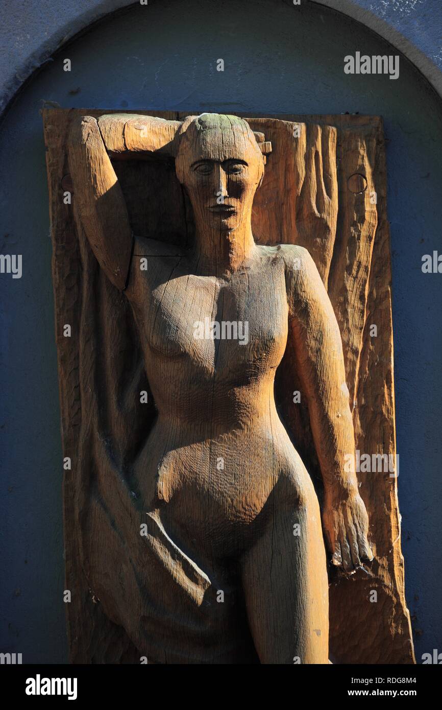 Wood sculpture of a woman's body on the Zehntturm tithe tower in Bischofsheim an der Rhoen, Rhoen-Grabfeld district Stock Photo