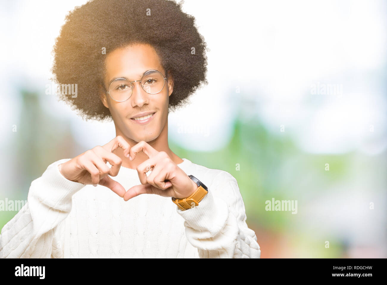 Young African American Man With Afro Hair Wearing Glasses Smiling