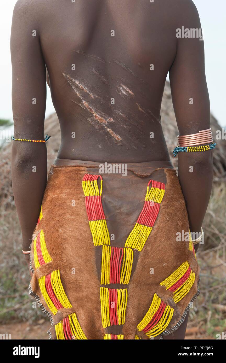 Young Hamar woman with traditional hairstyle with red clay and ...