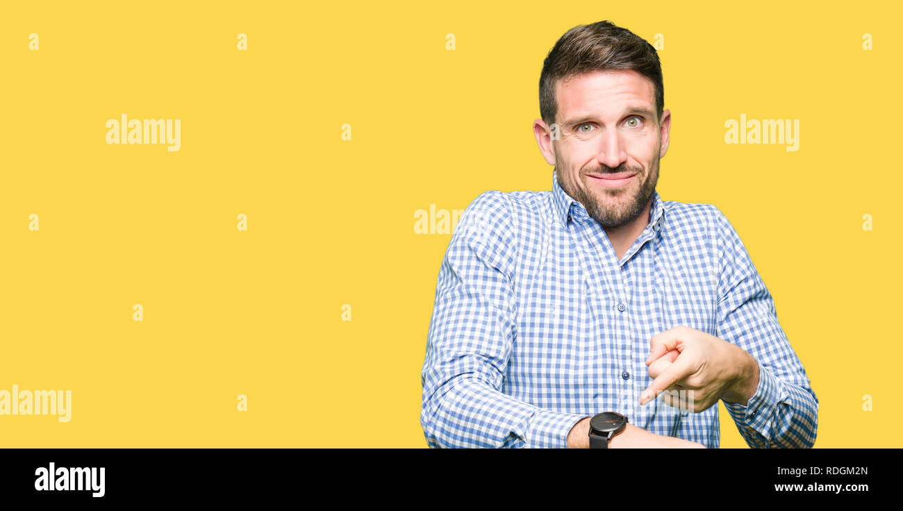 Handsome business man with blue eyes In hurry pointing to watch time, impatience, upset and angry for deadline delay Stock Photo