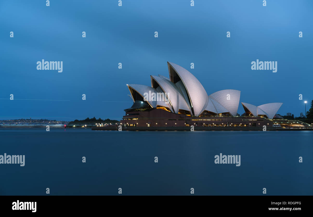 Iconic worlds' buildings - Sydney Opera house in full glory at sunset brightly illuminated Stock Photo