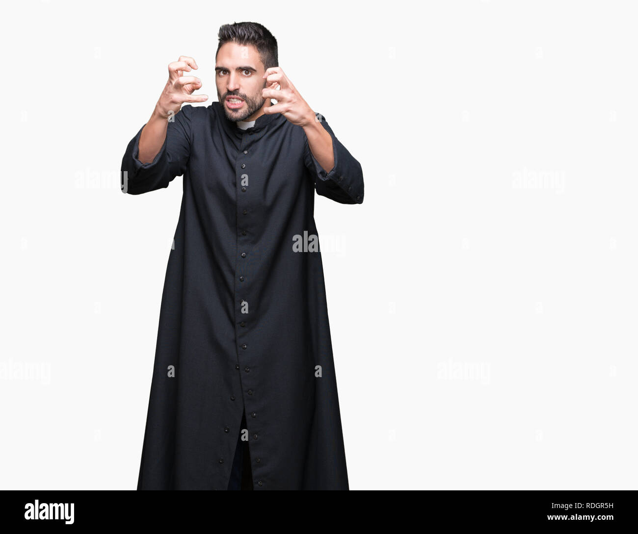 Young Christian priest over isolated background Shouting frustrated