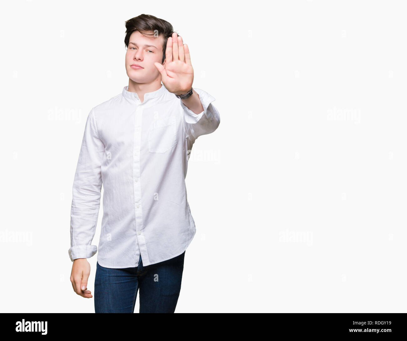 Young handsome business man over isolated background doing stop sing with palm of the hand. Warning expression with negative and serious gesture on th Stock Photo