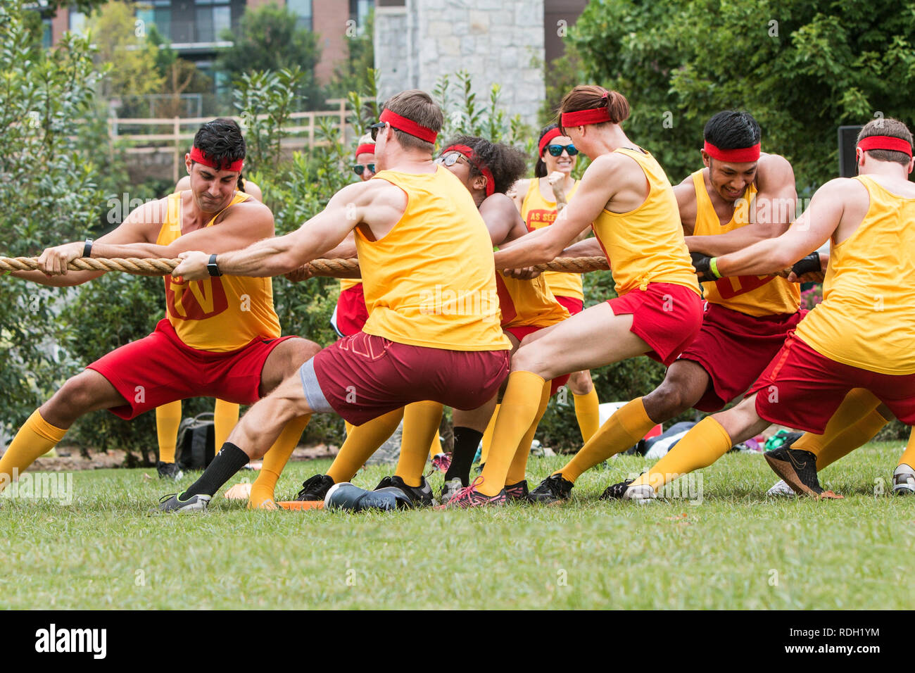 A team of young adult men and women compete in a tug of war contest