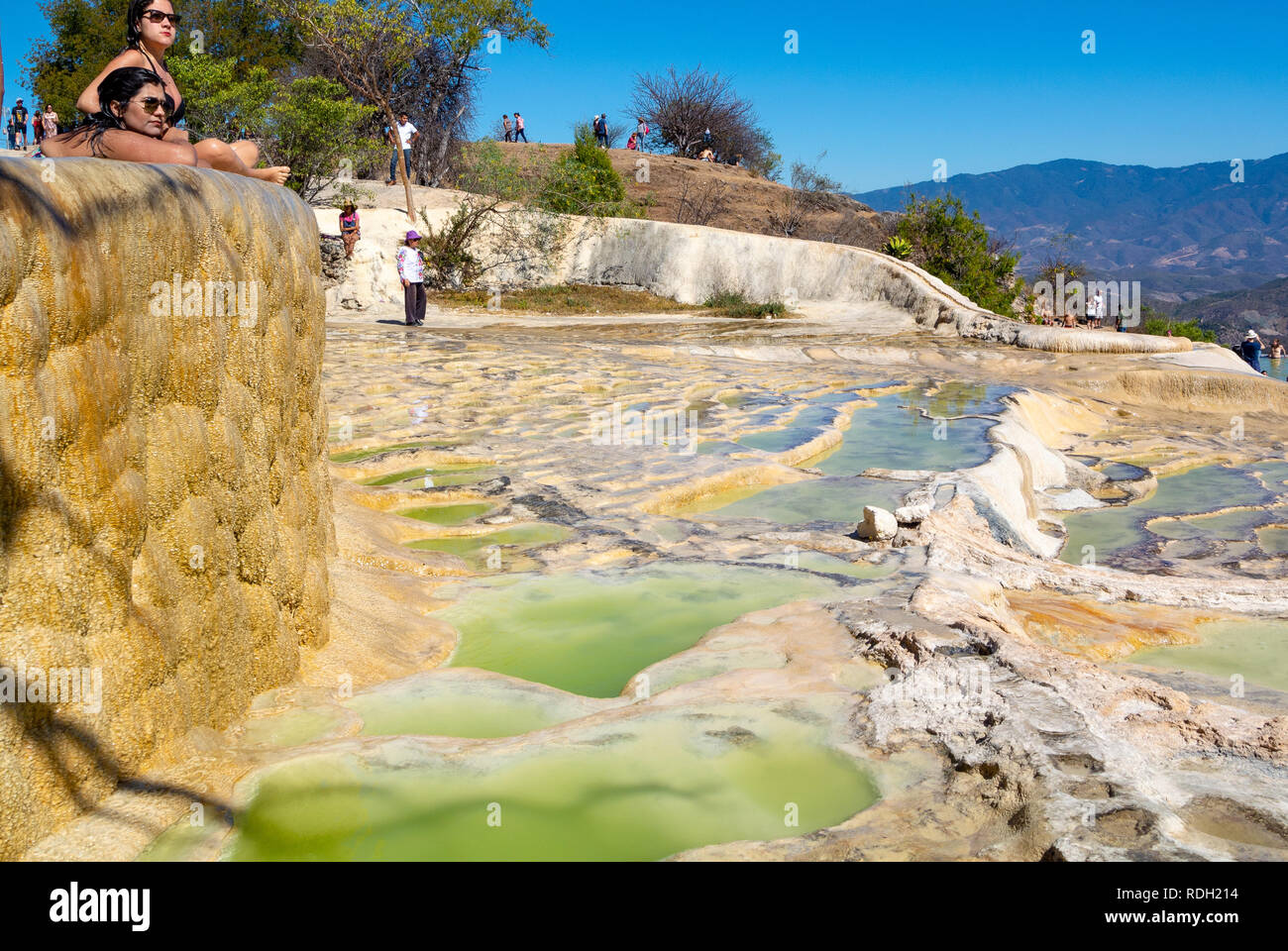 A landscape view of Hierve el Agua with tourists, Petrified waterfall, Oaxaca, Mexico Stock Photo