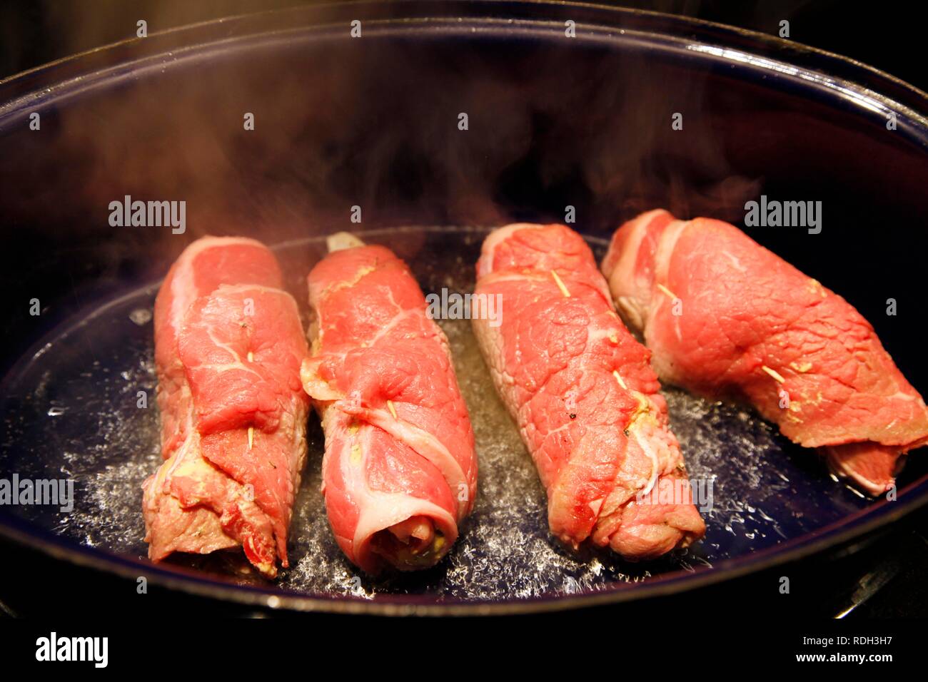 Beef roulades in a roasting dish Stock Photo