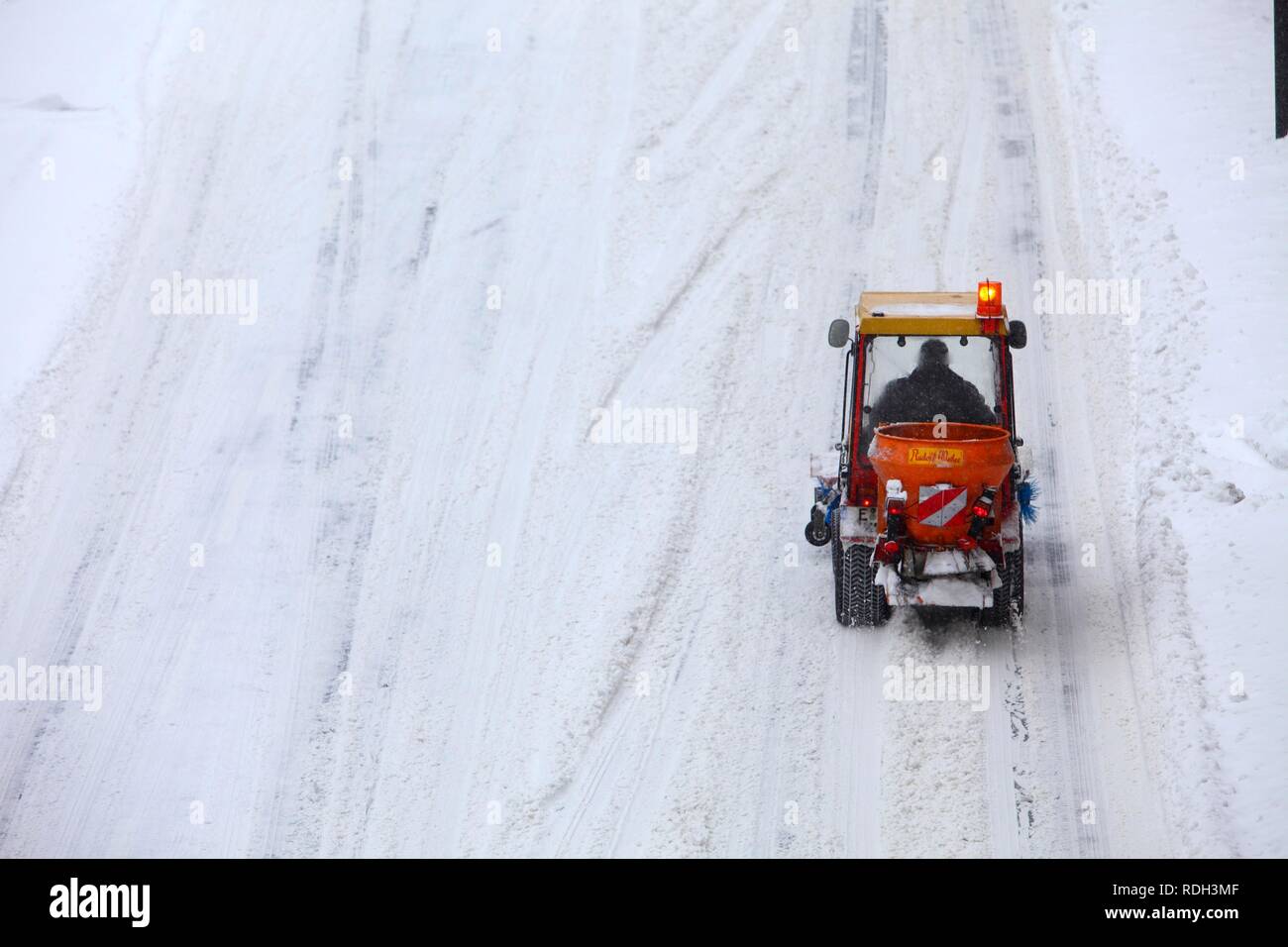 Small snow plough clearing a road, private company contracted by the city, Essen, North Rhine-Westphalia Stock Photo