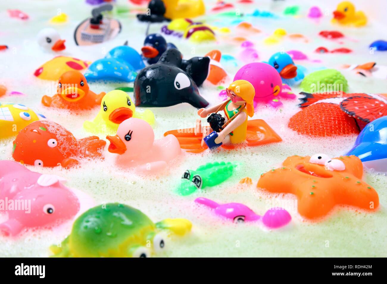 Various colourful water toys with bath foam Stock Photo
