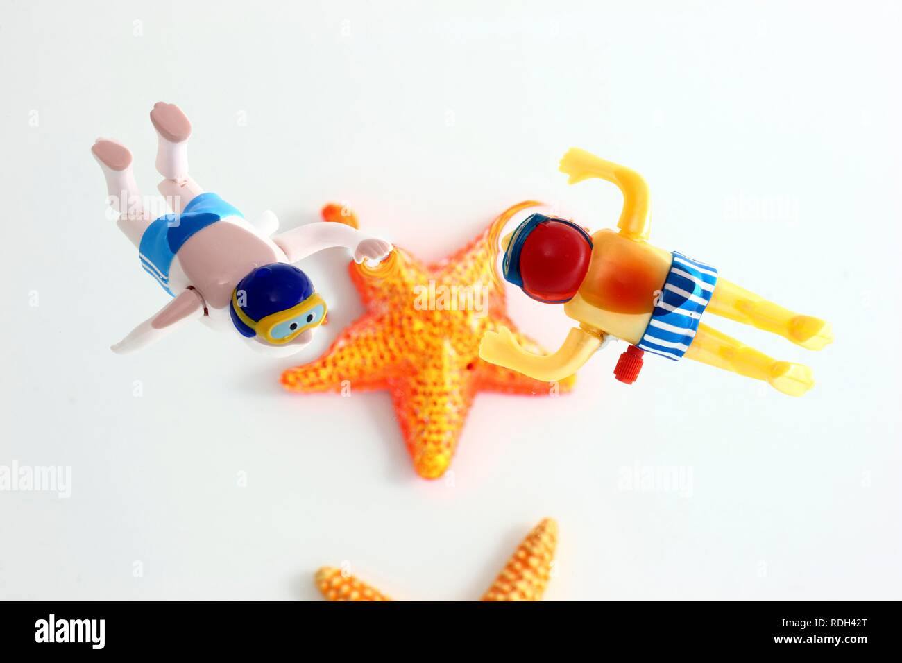Wind-up water toy divers and starfish Stock Photo