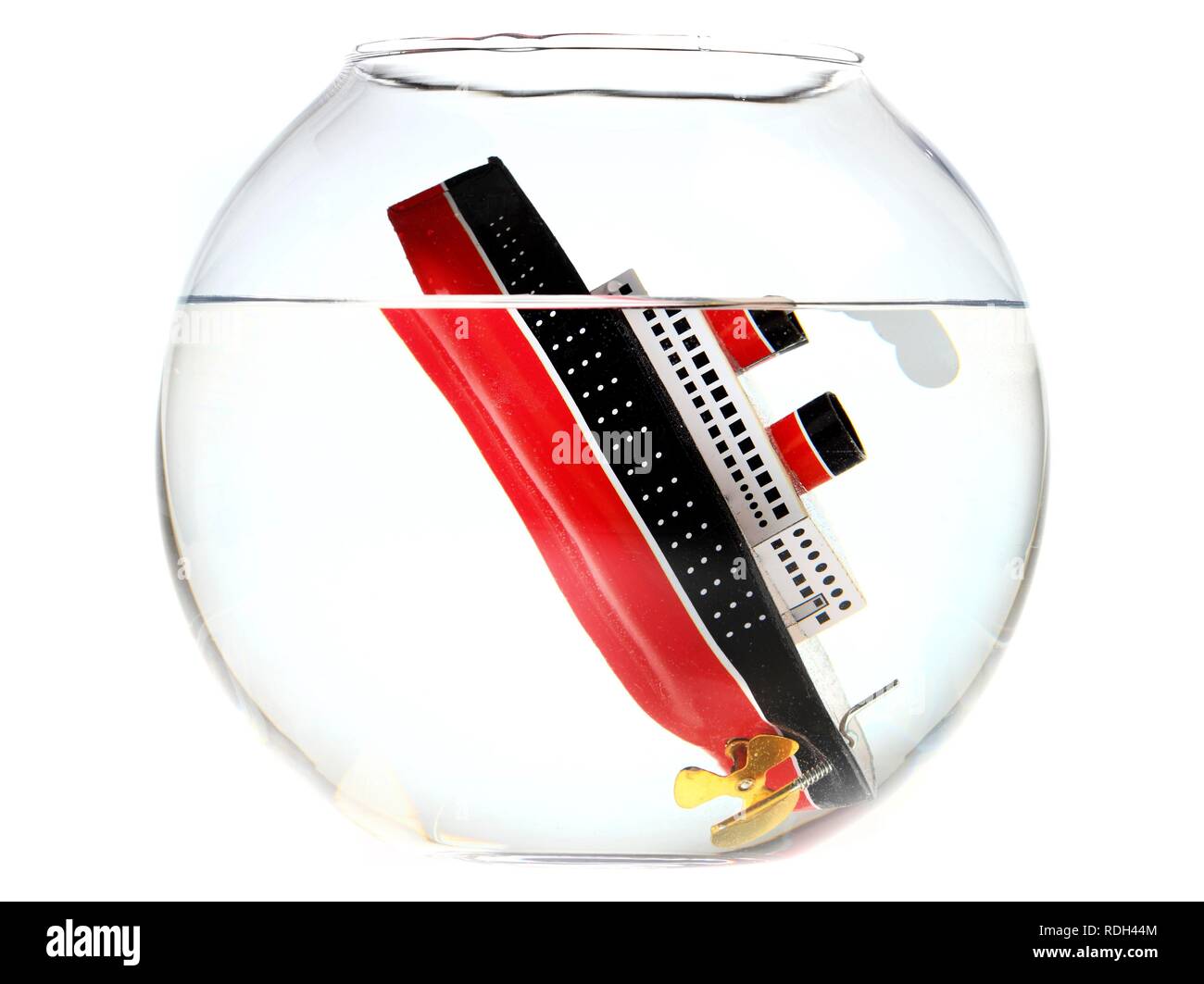 Sunken toy cruise ship in a fish bowl, illustration Stock Photo