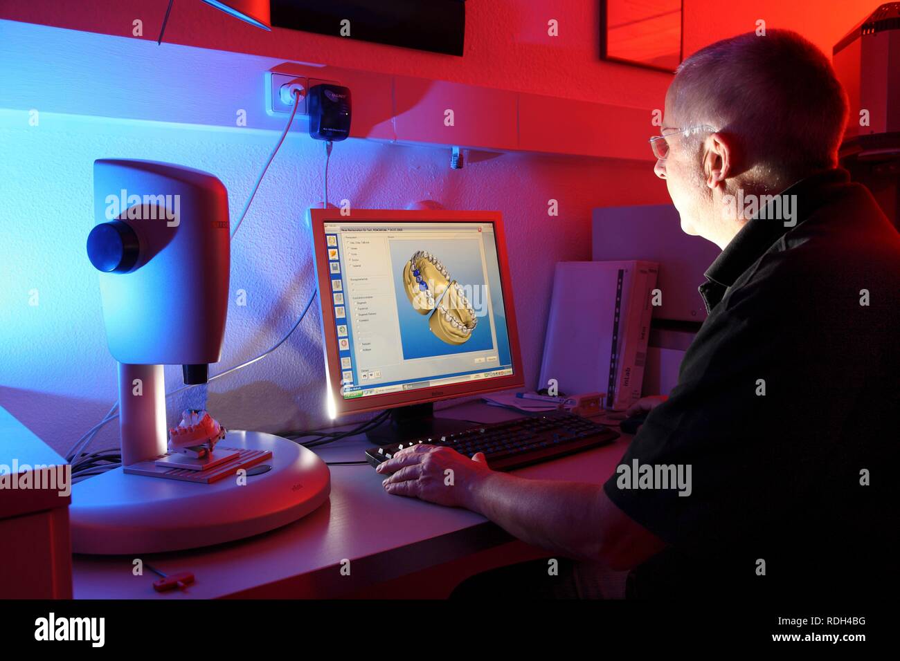 Dental laboratory, manufacture of a dental prostheses by a master craftsman, computer aided design for dental technology, Stock Photo