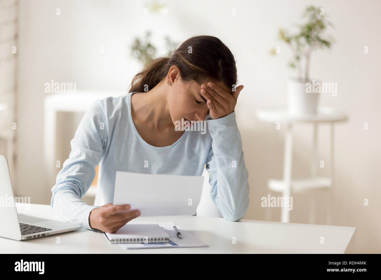 Upset stressed woman reading notification, bad news receiving Stock Photo