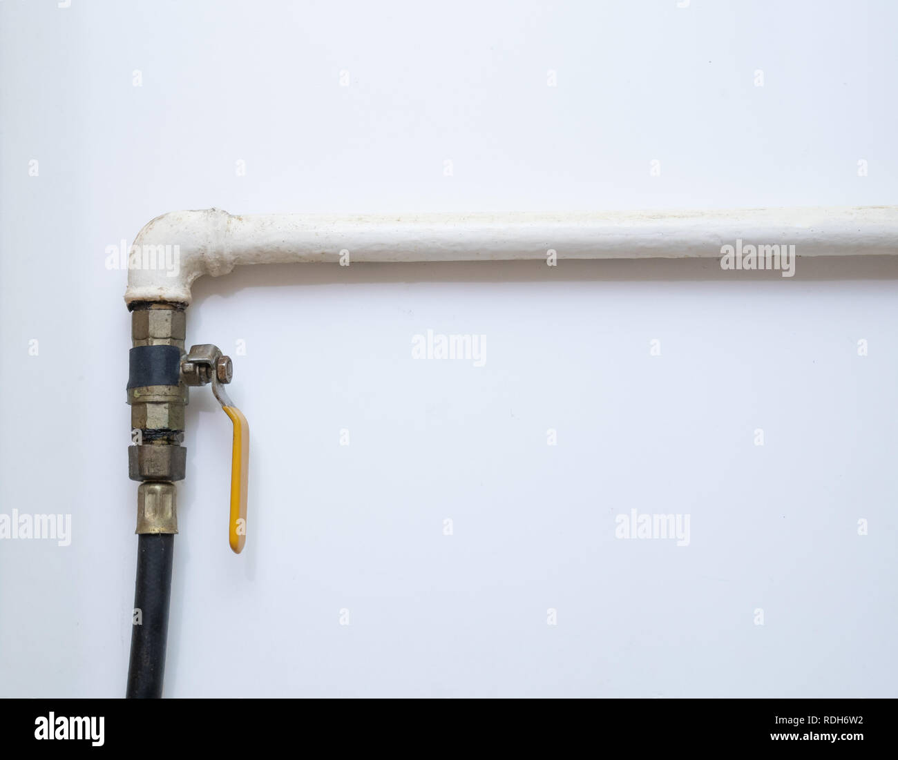 gas pipe with opened valve at home kitchen on white background Stock