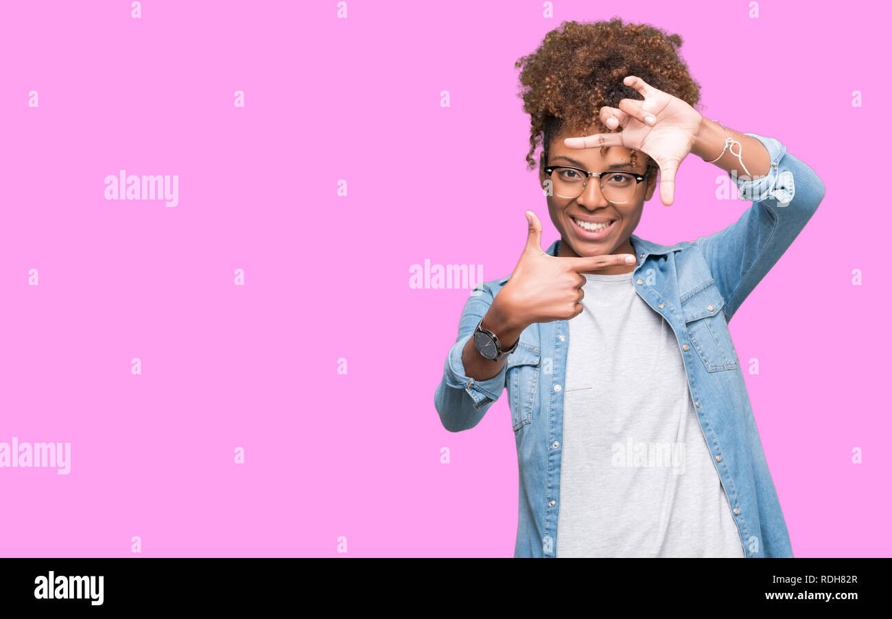 Beautiful young african american woman wearing glasses over isolated ...