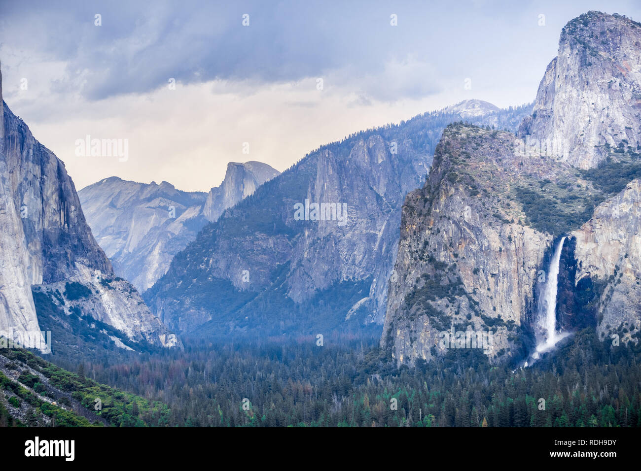 Bridalveil Falls and Yosemite Valley as seen from Tunnel View vista point on a rainy summer day, Yosemite National Park, California Stock Photo