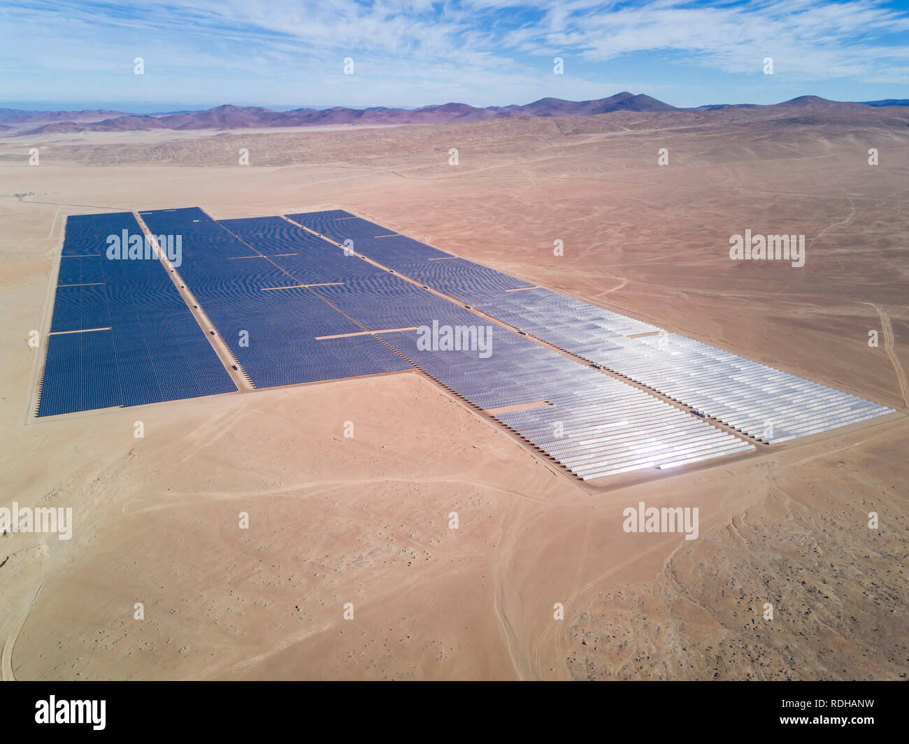Solar Energy Farm in the middle of Atacama Desert. An awe arid landscape to generate energy from the Sun with a Solar Photovoltaic Power Plant, Chile Stock Photo