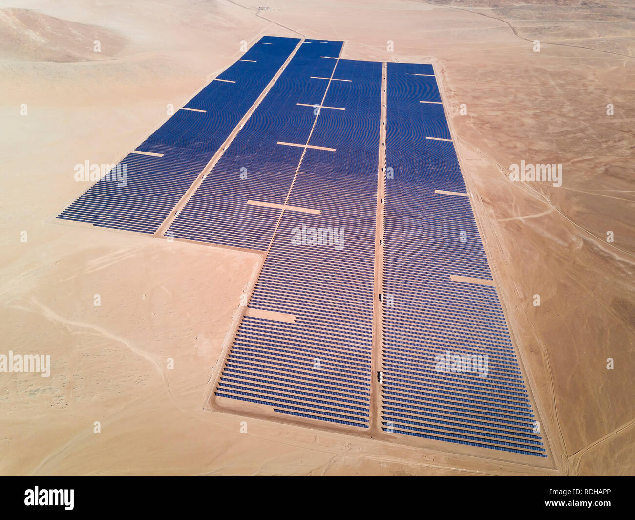 Solar Energy Farm in the middle of Atacama Desert. An awe arid landscape to generate energy from the Sun with a Solar Photovoltaic Power Plant, Chile Stock Photo