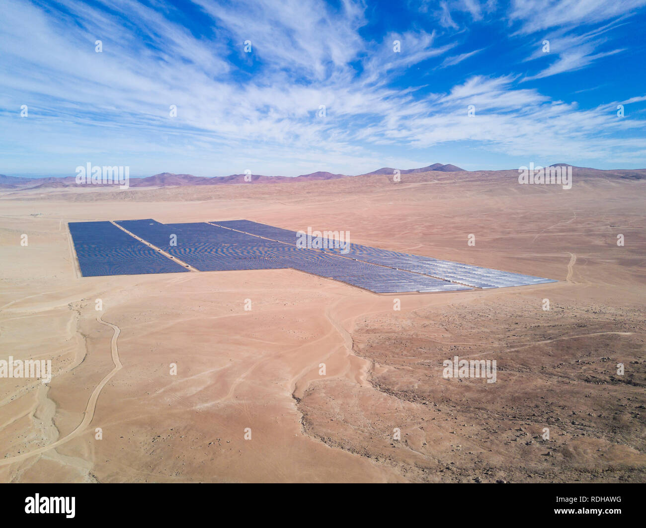 Solar Energy Farm in the middle of Atacama Desert. An awe arid landscape to generate energy from the Sun with a Solar Photovoltaic Power Plant, Chile Stock Photo