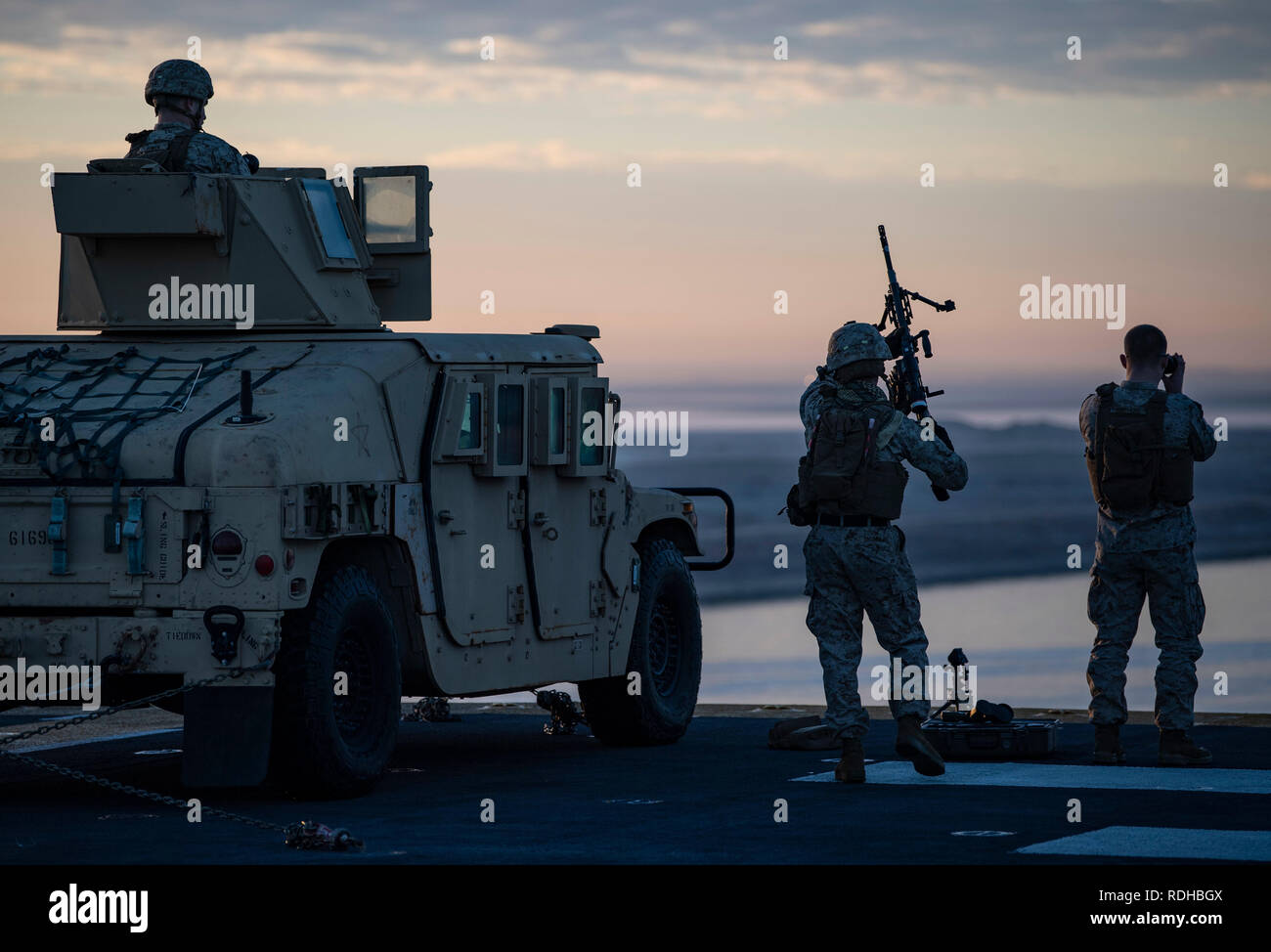 190112-N-UP035-0045 SUEZ CANAL (Jan. 12, 2019) - U.S. Marines attached to the 22nd Marine Expeditionary Unit stand watch aboard the Wasp-class amphibious assault ship USS Kearsarge (LHD 3) as it transits the Suez Canal, Jan. 12, 2019. Kearsarge is the flagship for the Kearsarge Amphibious Ready Group and, with the embarked 22nd Marine Expeditionary Unit, is deployed to the U.S. 5th Fleet area of operations in support of naval operations to ensure maritime stability and security in the Central region, connecting the Mediterranean and the Pacific through the western Indian Ocean and three strate Stock Photo