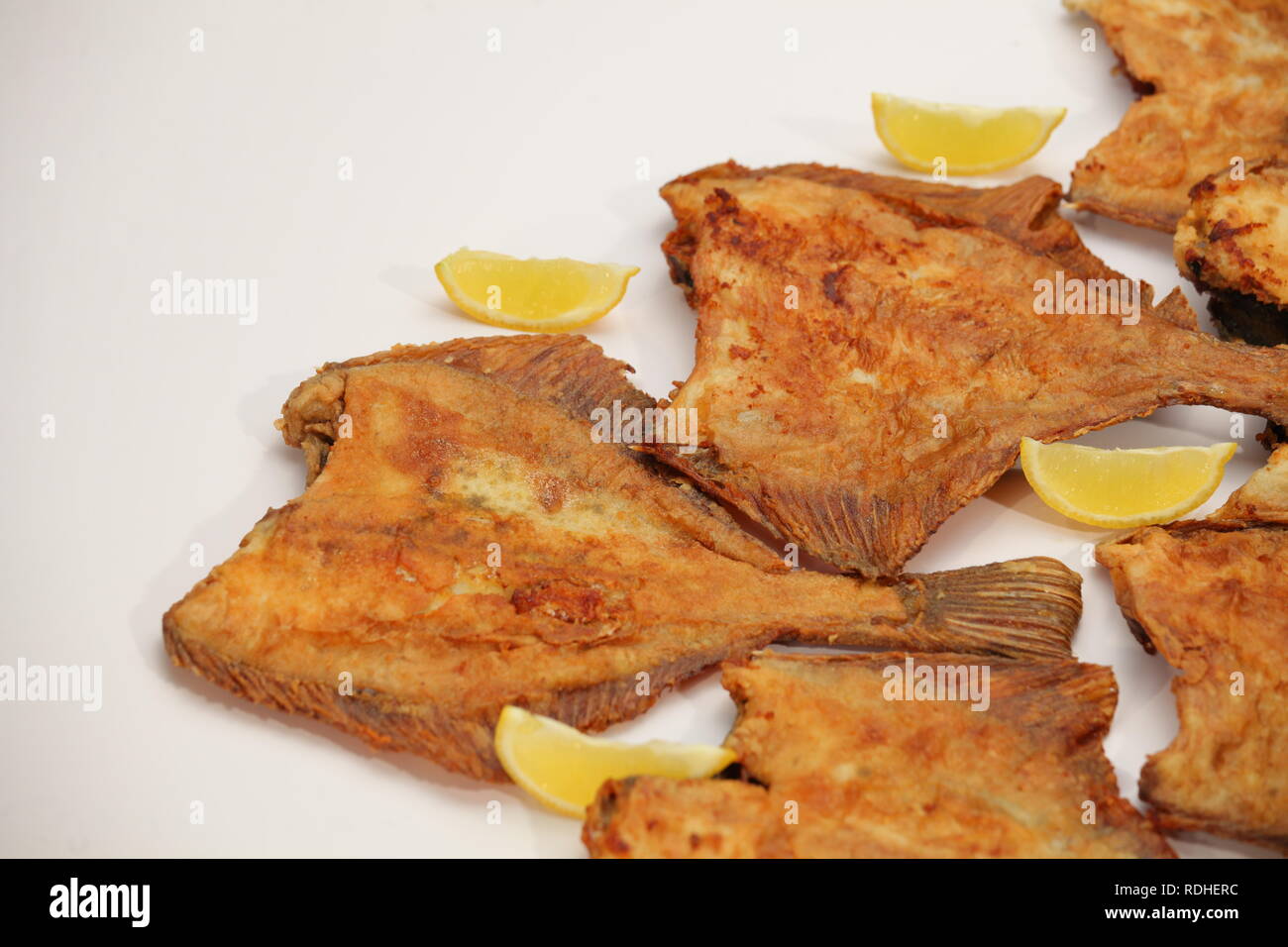 Fried sea flat fish with lemon Stock Photo - Alamy