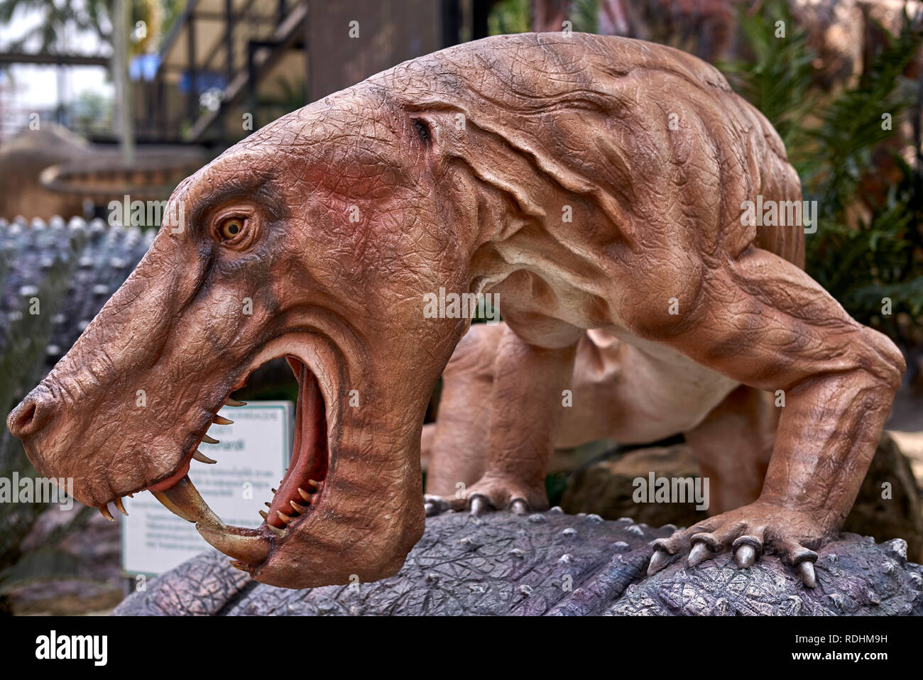 A carnivorous Sabre-Tooth Tiger attacking a young Deinotherium