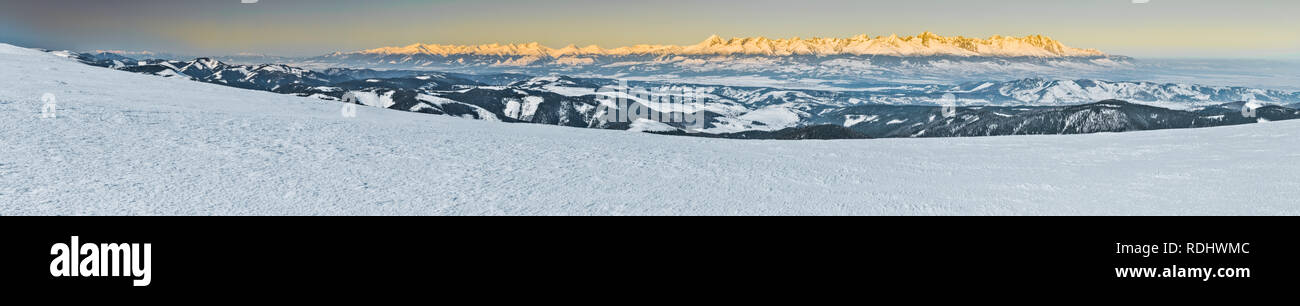 Panorama of High Tatras mountains in Slovakia during sunrise in winter. Stock Photo