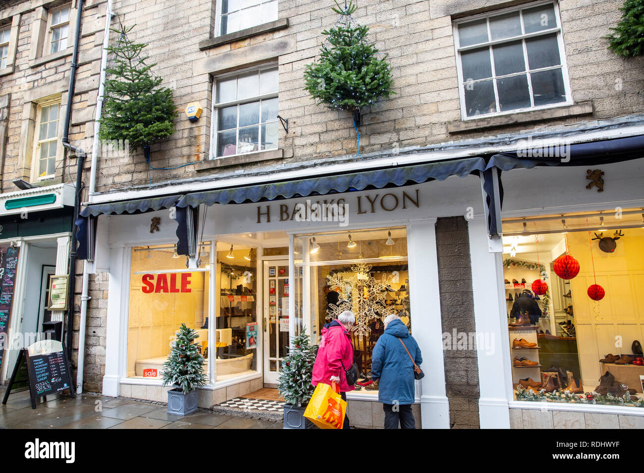 Lancaster city centre, christmas tress in the high street amongst shops