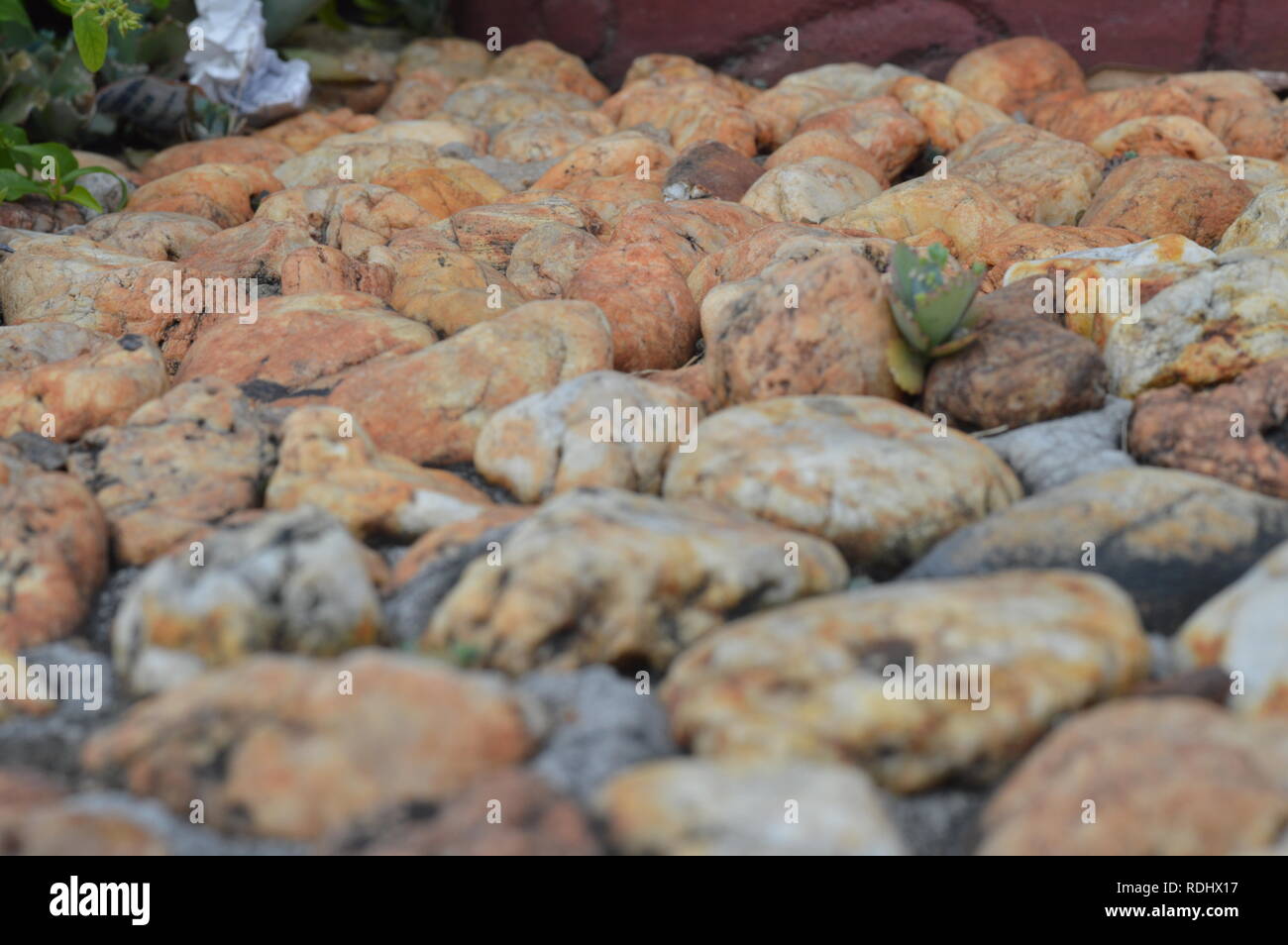 Brown / bronze stones and rocks on the ground Stock Photo - Alamy