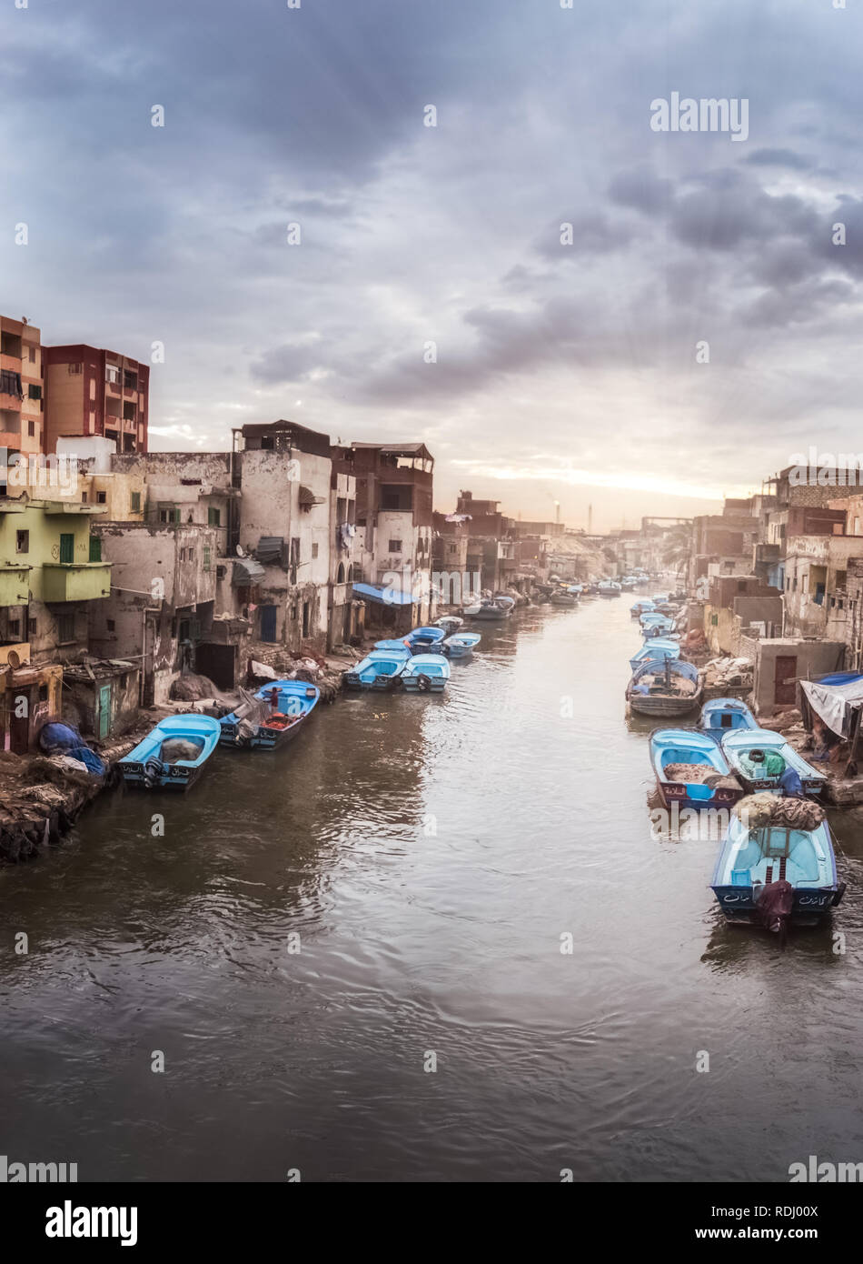 Dramatic sky and sunrise, clouds and boats in The Fishing Village of Al Maks with in Alexandria Egypt . Al Maks (also spelled El Max) is one of the ne Stock Photo