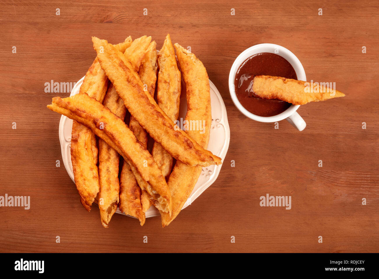 Traditional Spanish porras with hot chocolate, typical Madrid Sunday