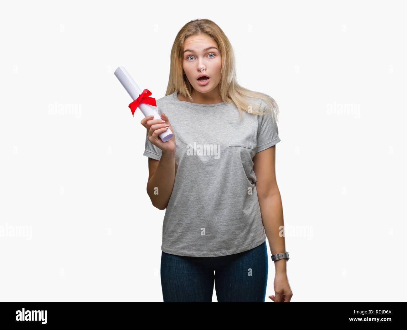 Young caucasian woman holding degree over isolated background scared in ...