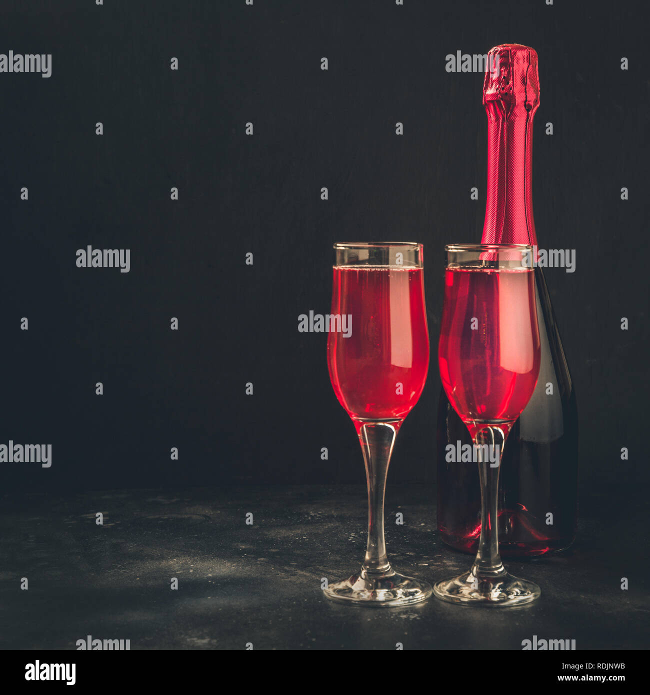 Valentine's day and birthday greeting card with red champagne on black.  Space for text Stock Photo - Alamy