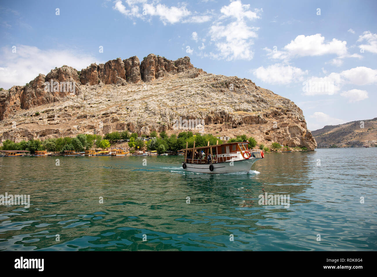 Gaziantep, Turkey - June 08, 2014: Tourist trip boat in Rumkale on June 08, 2014. Rumkale is located on a hill covered by high rocks, where the Firat  Stock Photo