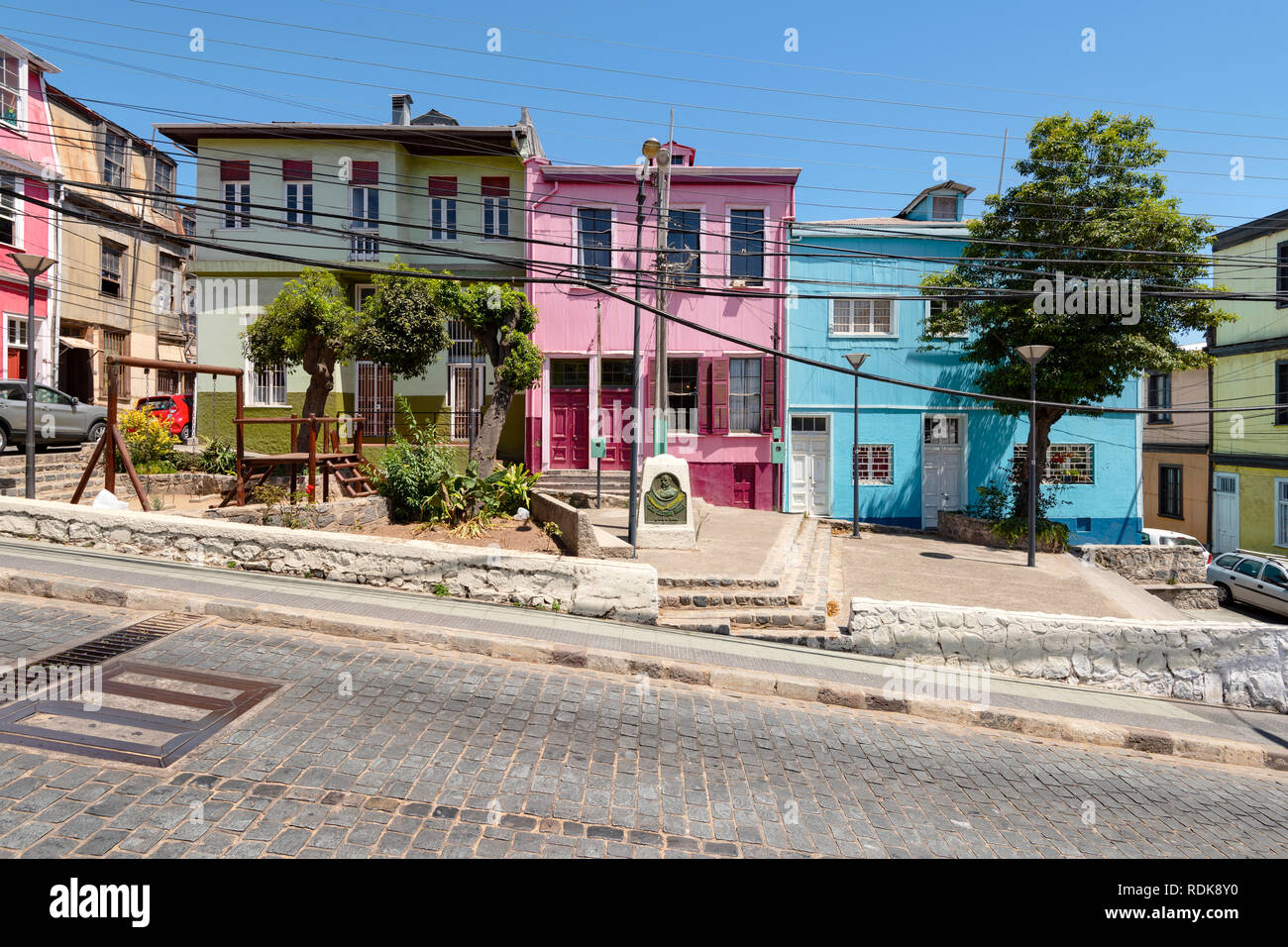 Some colourful buildings beside a street on the steep hills around Valparaiso, Chile. Stock Photo