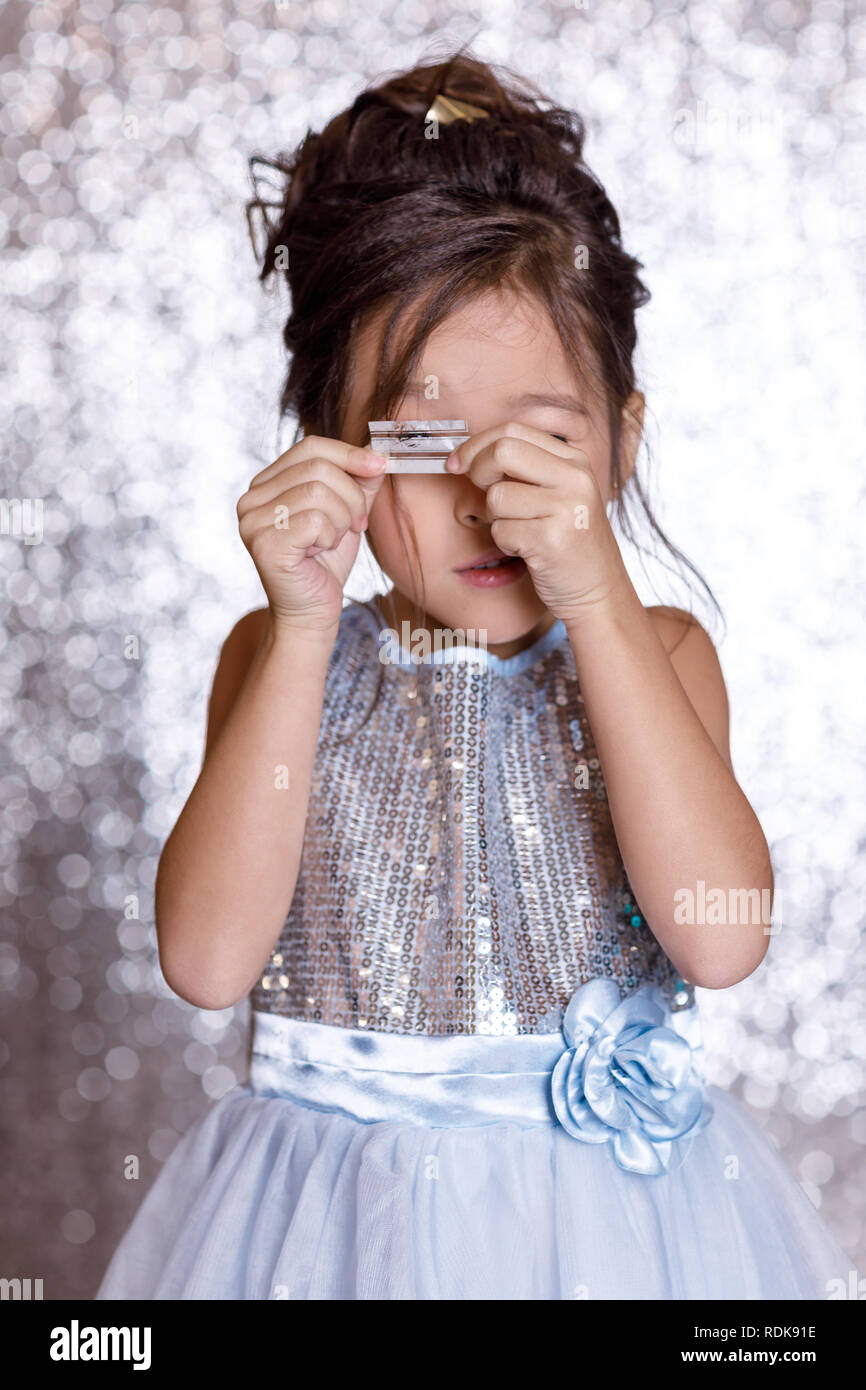 cute smiling little child girl in silver and blue dress Stock Photo - Alamy