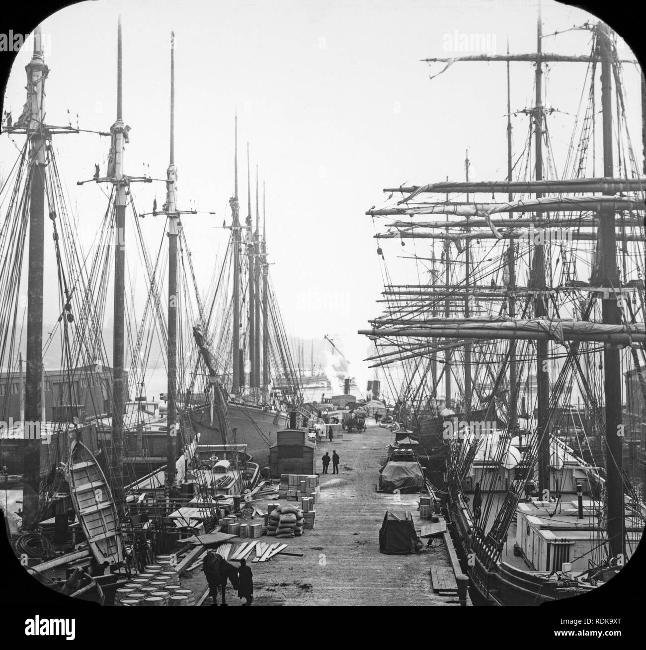 Late Victorian view of the docks in New York City. many sailing ships can be seen loading or unloading their goods. Stock Photo
