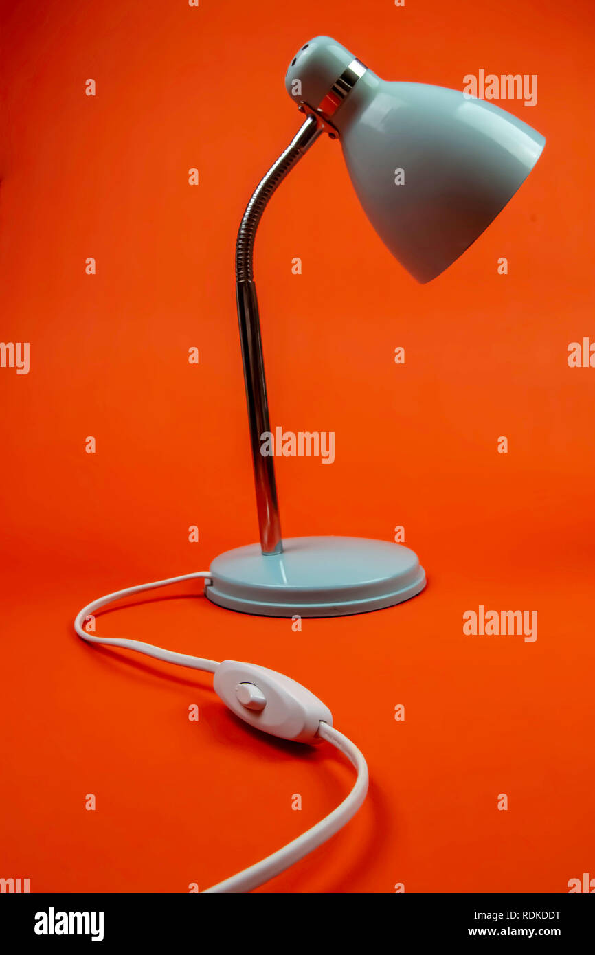 Orange Background with Blue Lamp modelled infront Stock Photo