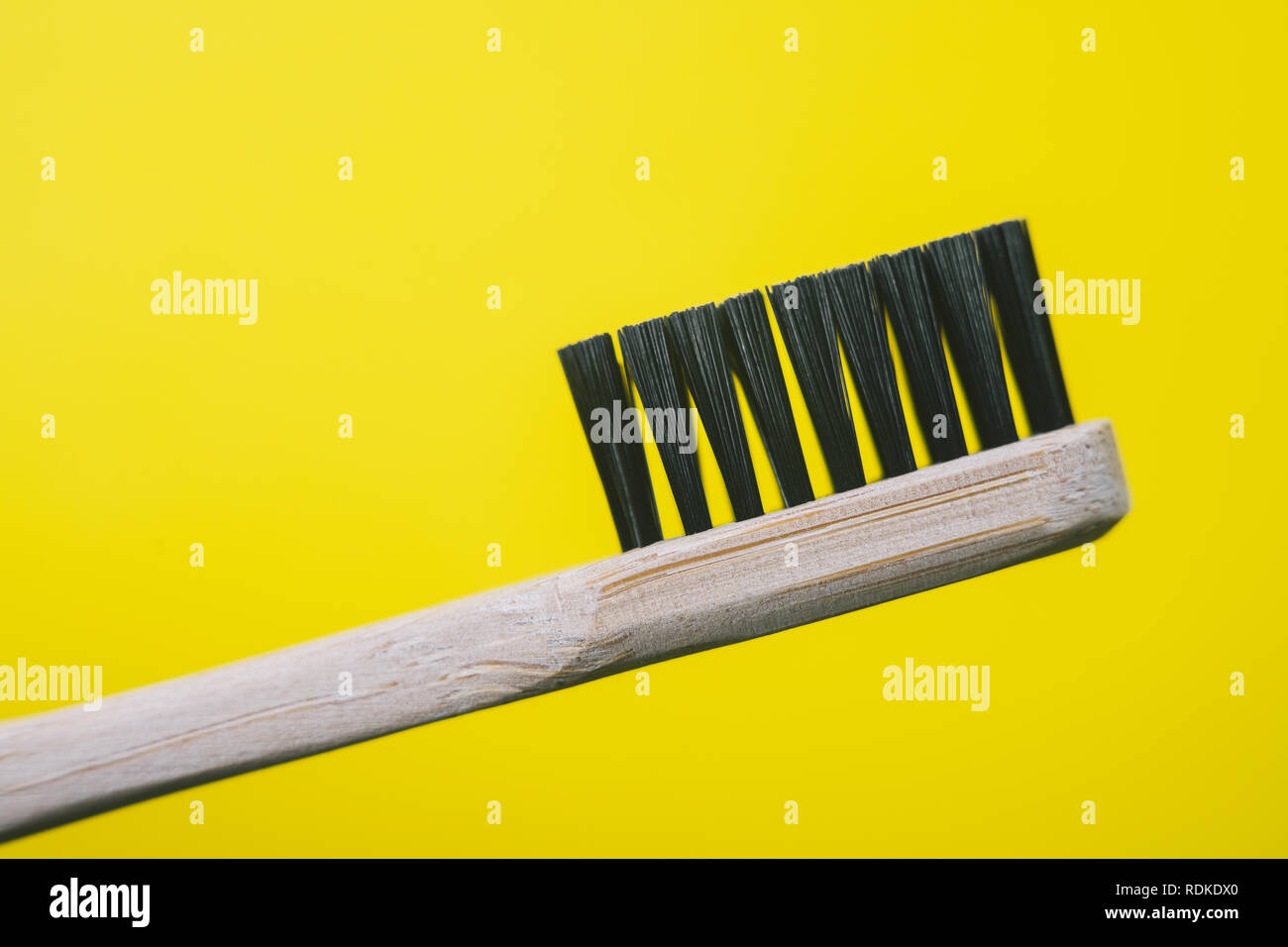 Bamboo toothbrush isolated on yellow background Stock Photo - Alamy