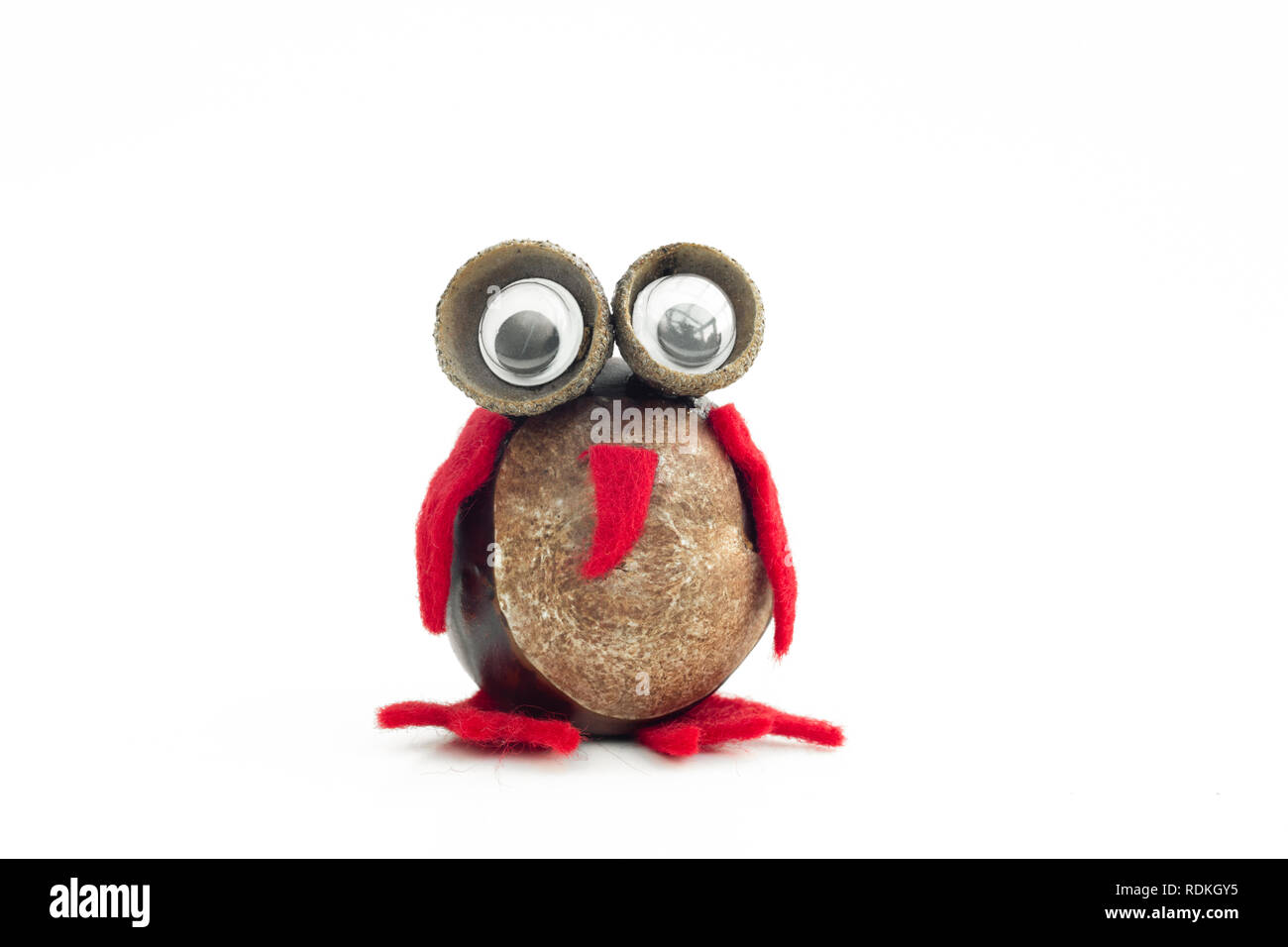Funny owl shape character or figurine made with chestnuts in white isolated background. Stock Photo