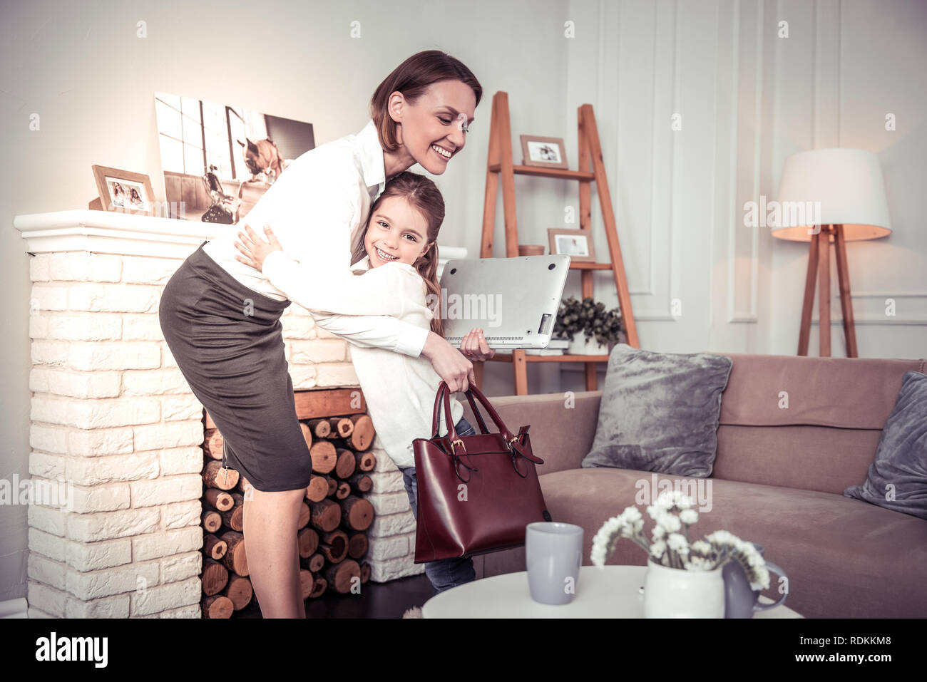 Joyful positive girl meeting her mom from work Stock Photo Alamy