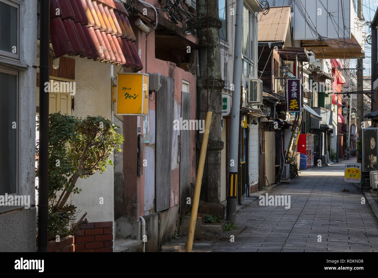 Beppu, Japan - November 3, 2018: Small street in the centre of the city of Beppu with signs and lots of electricity wires Stock Photo