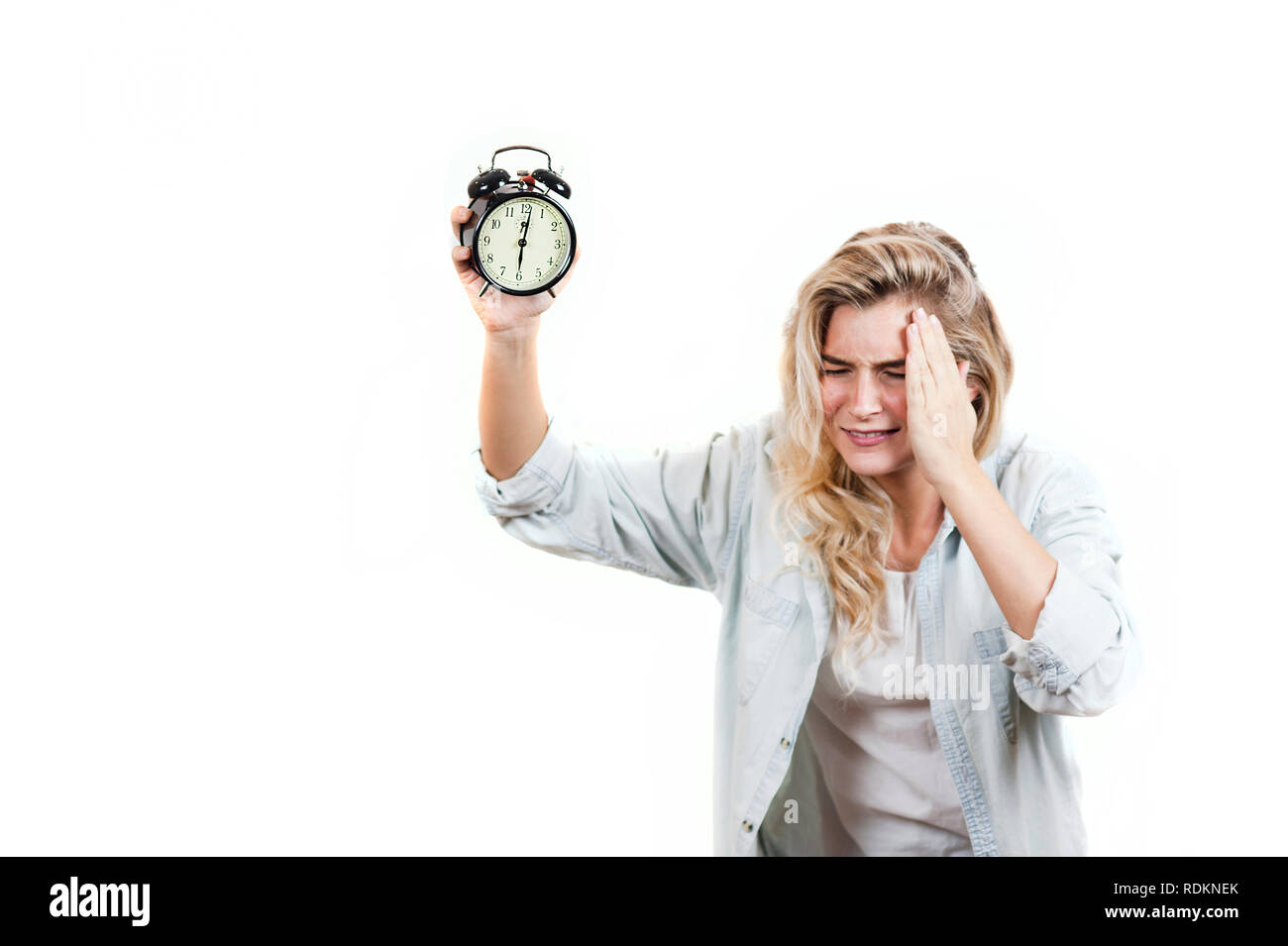 Very beautiful girl tired with a headache from the fact that the alarm