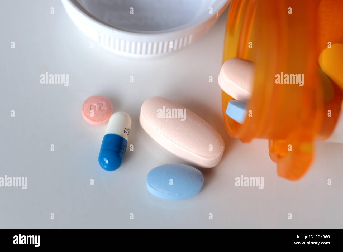 Medicine pills spill bottle white background Stock Photo
