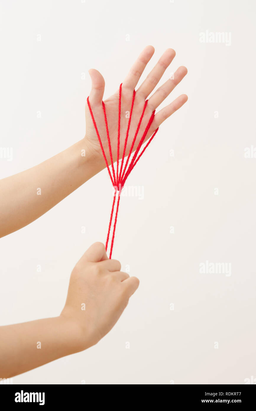 Japanese woman playing with red string Stock Photo - Alamy